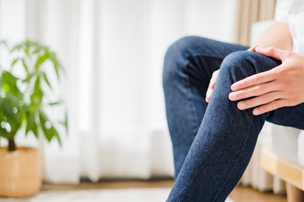 膝をおさえている女性の足元