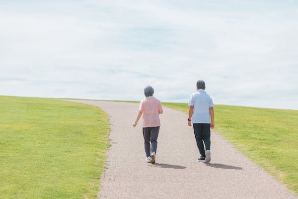 並んで散歩している高齢男女