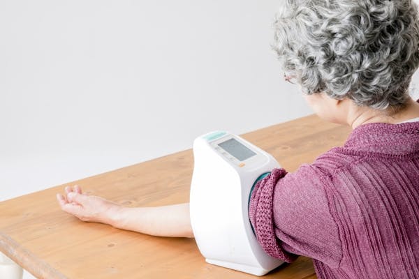 血圧を測定する白髪の女性