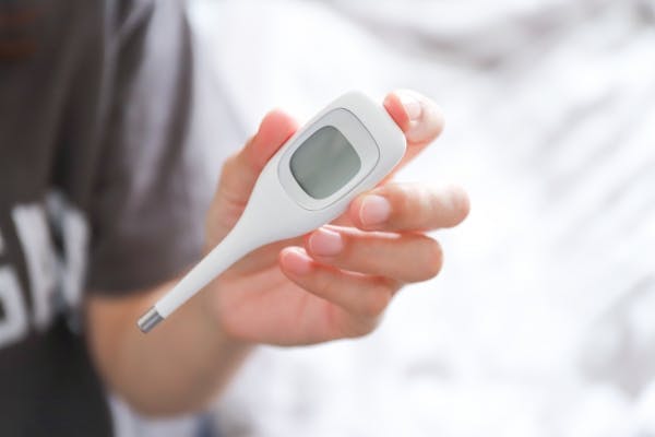電子体温計を持っている手