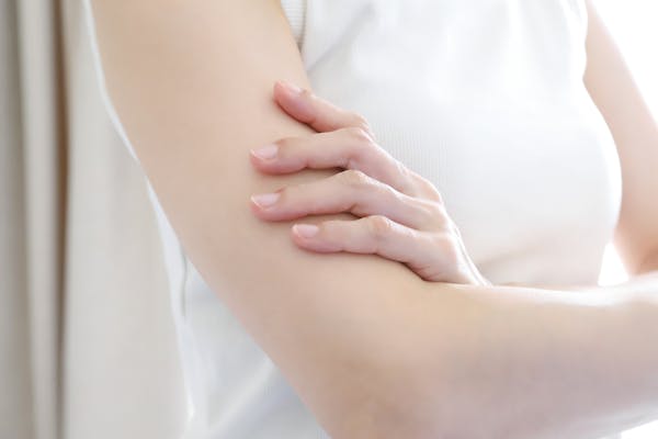 腕を組む女性の二の腕